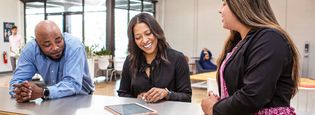 three professionals in meeting